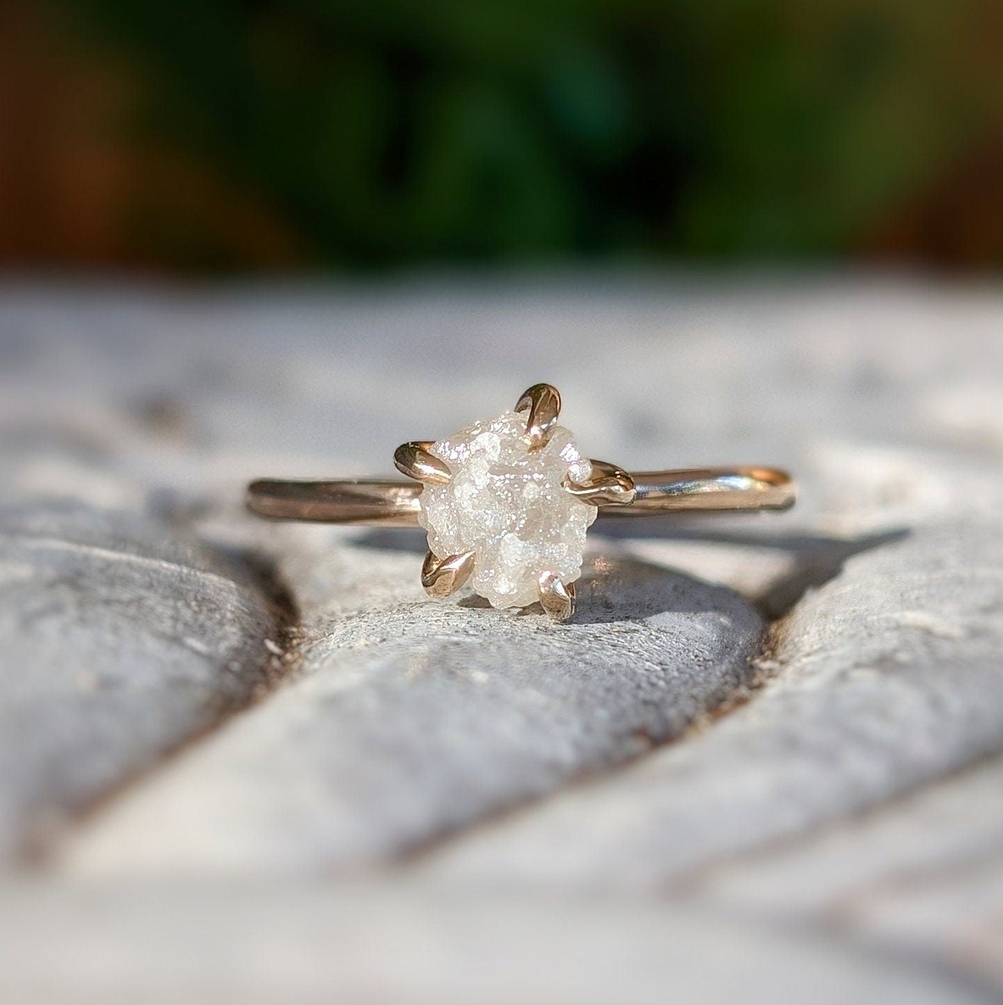 Raw diamond engagement ring set in gold, showcasing its unique, uncut diamond and natural beauty.