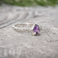 Amethyst engagement ring in solid sterling silver with pear-shaped purple crystal and textured band.