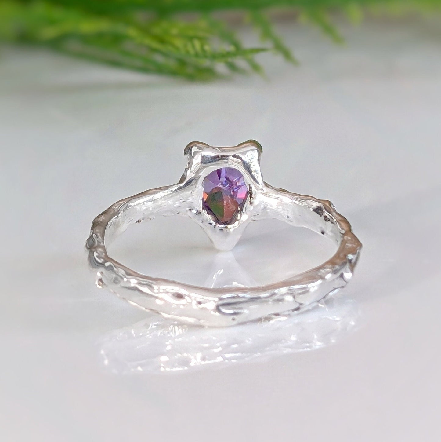 Handcrafted solid sterling silver amethyst engagement ring with organic textured band and pear-shaped purple crystal.