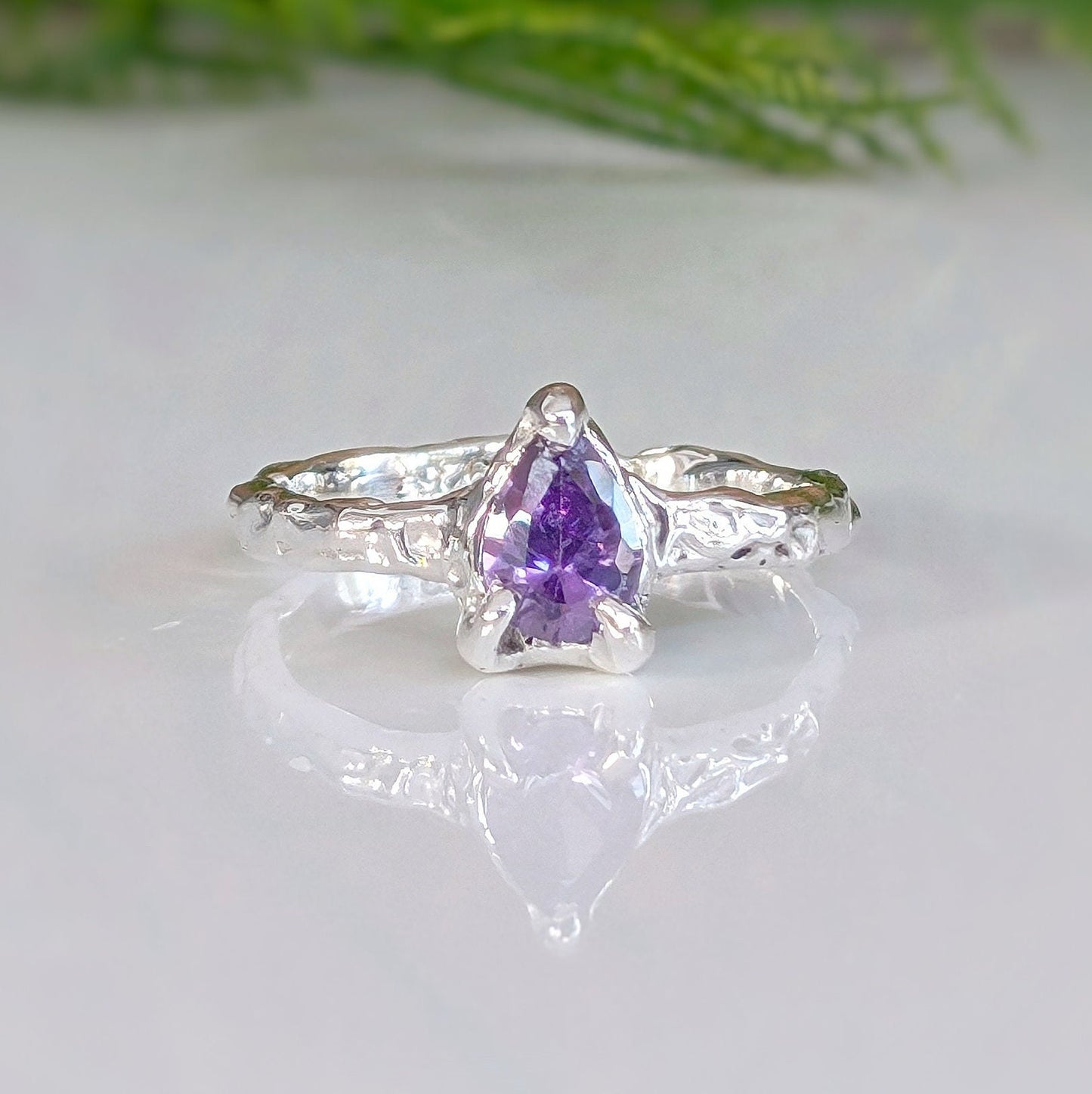 Handcrafted Amethyst engagement ring in solid sterling silver with organic textured band and pear-shaped stone.