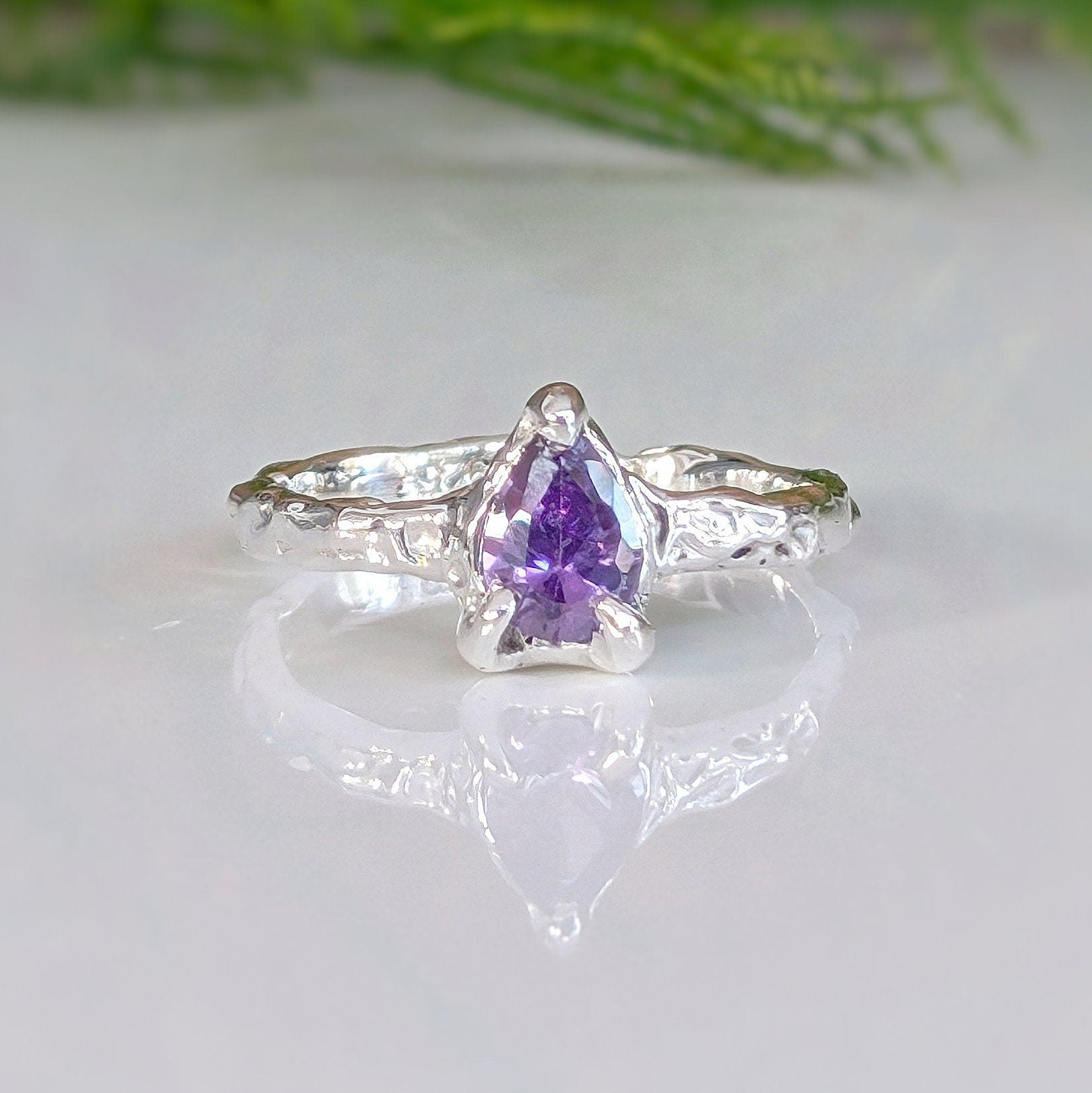 Handcrafted Amethyst engagement ring in solid sterling silver with organic textured band and pear-shaped stone.