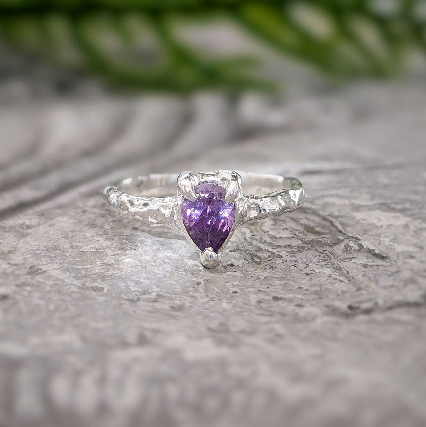 Amethyst engagement ring in solid sterling silver with pear-shaped gemstone on a textured band.