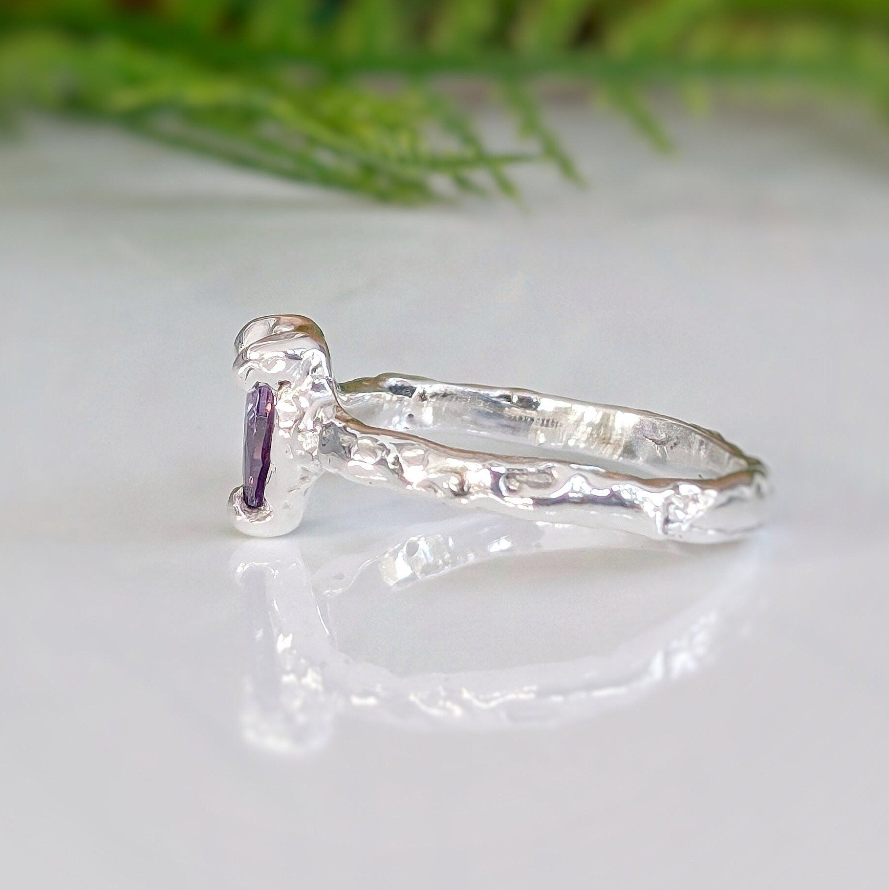 Amethyst engagement ring in solid sterling silver with a textured band and pear-shaped purple crystal, handcrafted design.
