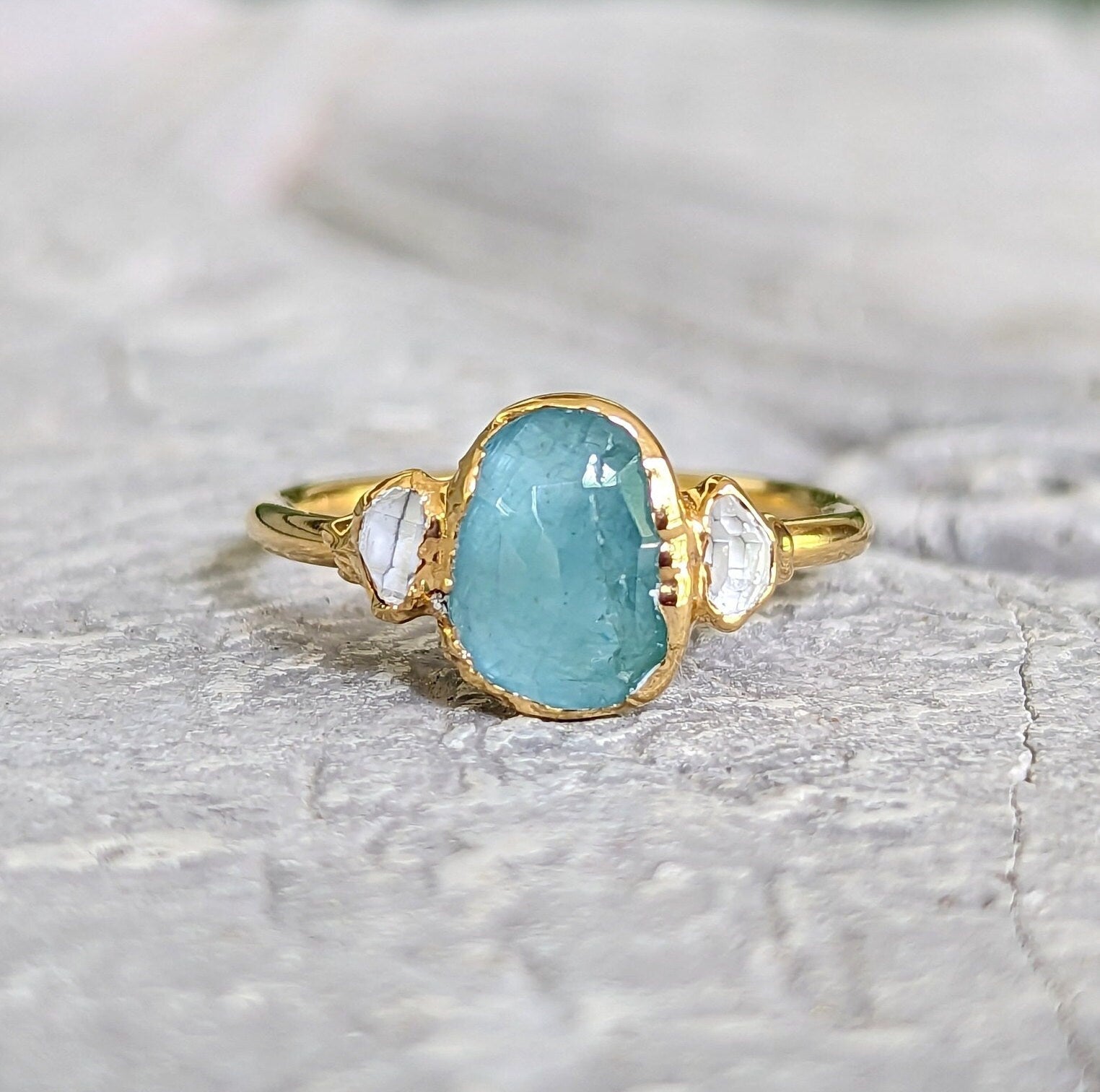 Aqua blue Grandidierite and Herkimer diamond ring set in 18k gold, showcasing unique craftsmanship and elegance.