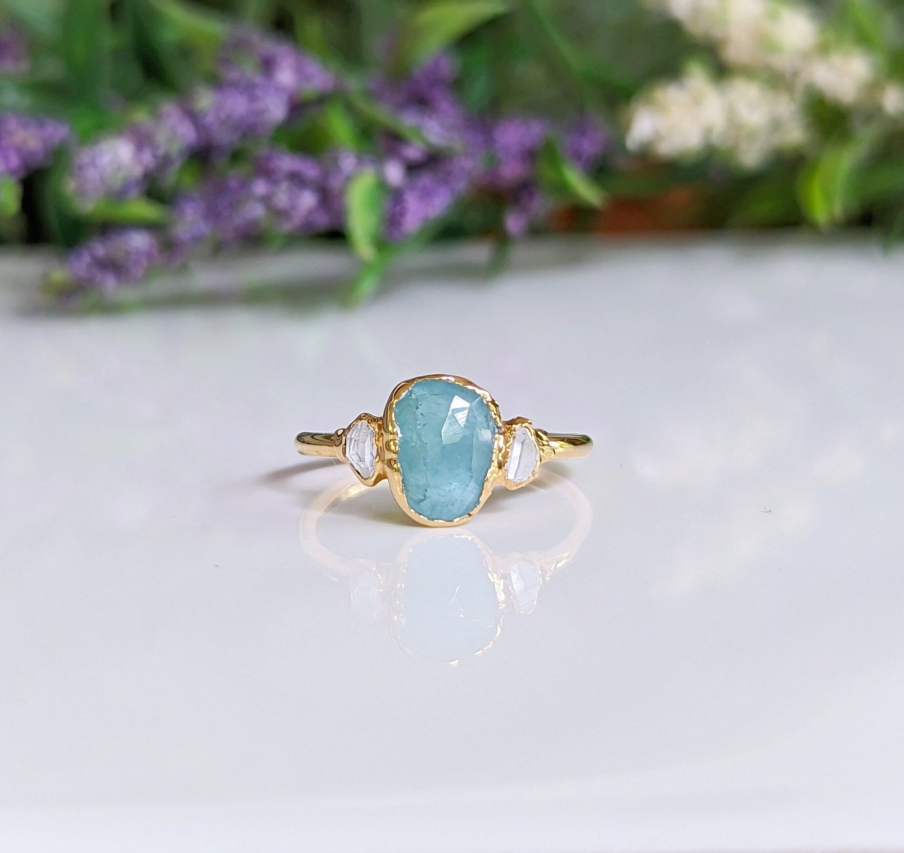 Aqua blue Grandidierite and diamond ring in 18k gold, featuring a rose cut gemstone and Herkimer diamonds.