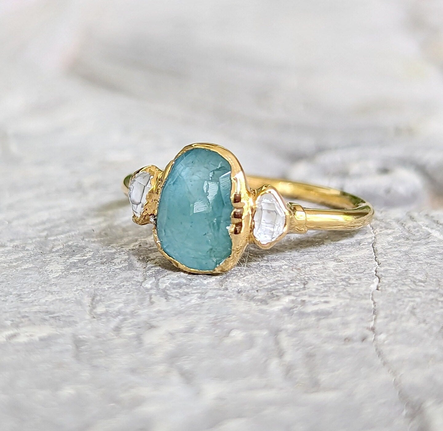 Aqua blue Grandidierite and diamond ring in 18k gold, featuring a unique rose cut gemstone.