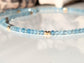 Handmade aquamarine bead necklace with natural gemstones and gold spacers, reflecting calmness and serenity.