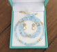 Aquamarine and Opal bridal jewelry set in a blue presentation box, featuring earrings and a necklace.