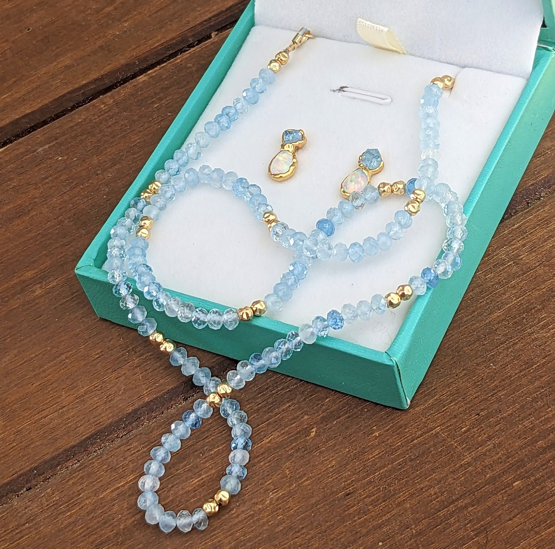 Aquamarine and Opal bridal jewelry set featuring raw Aquamarine bead necklace and stud earrings in a gift box.