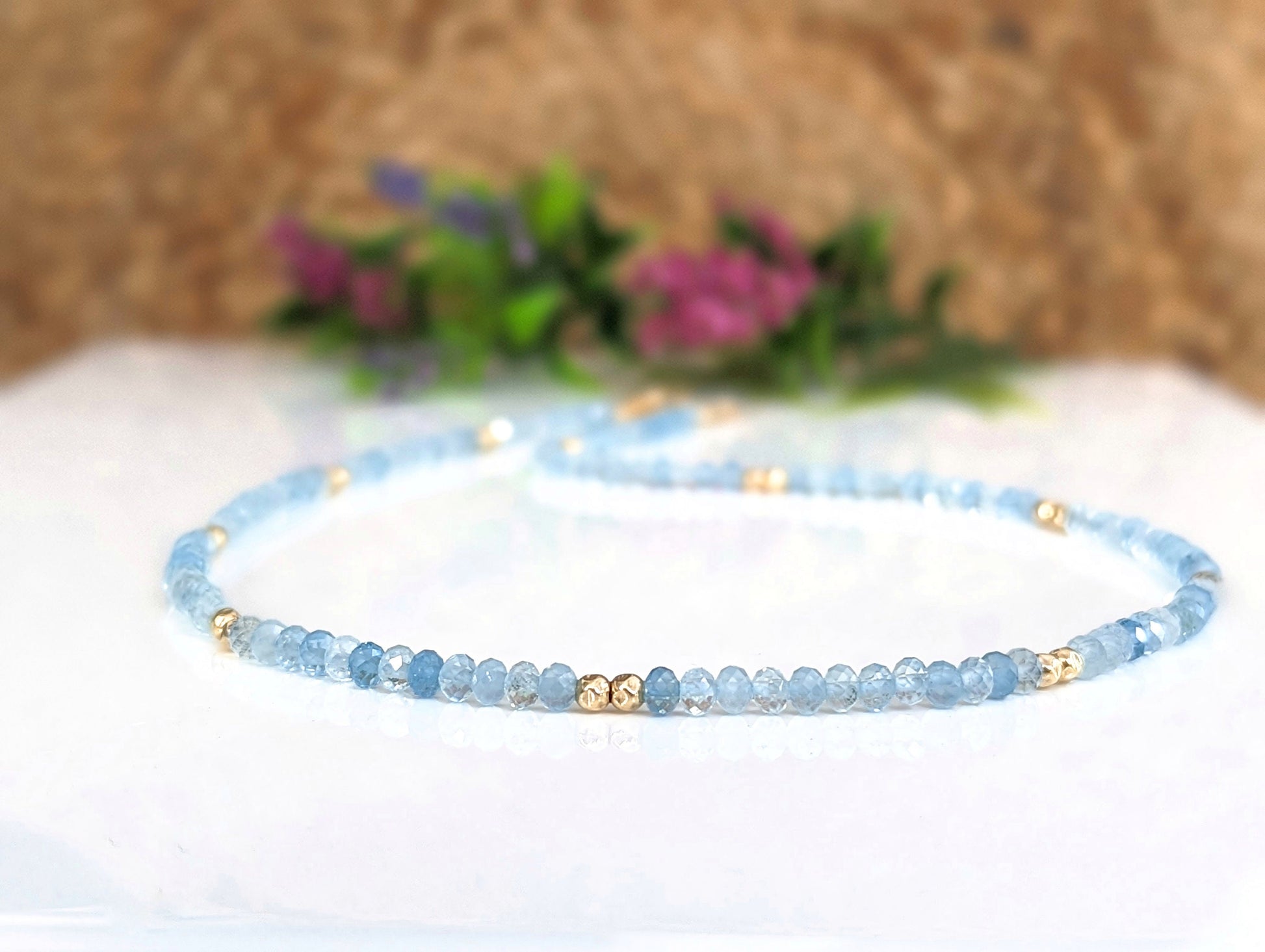 Aquamarine bead necklace with gold accents, showcasing delicate blue hues for bridal elegance.