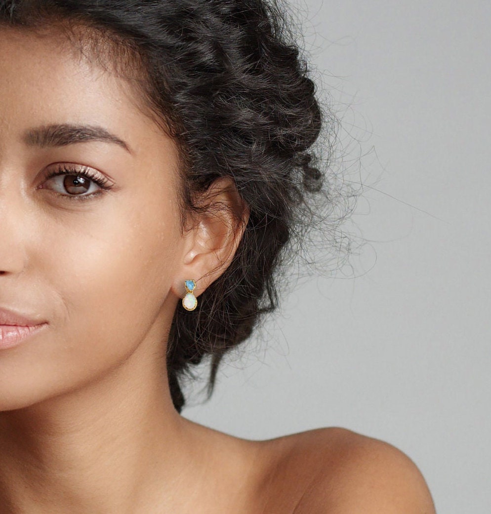 Model showcasing Aquamarine and Opal stud earrings, highlighting the delicate design for a bridal jewelry set.