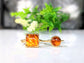 Baltic Amber gold rings featuring unique natural stones on elegant bands, showcasing vibrant hues and individual designs.