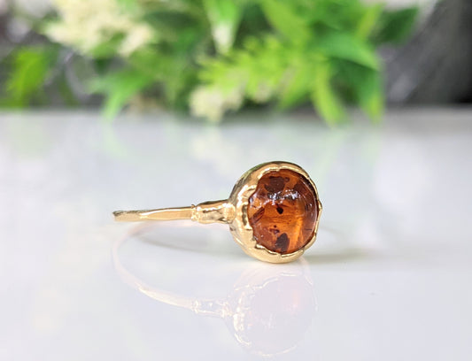 Baltic Amber gold ring featuring an 8mm round stone on a hammered gold band, unique and handmade.