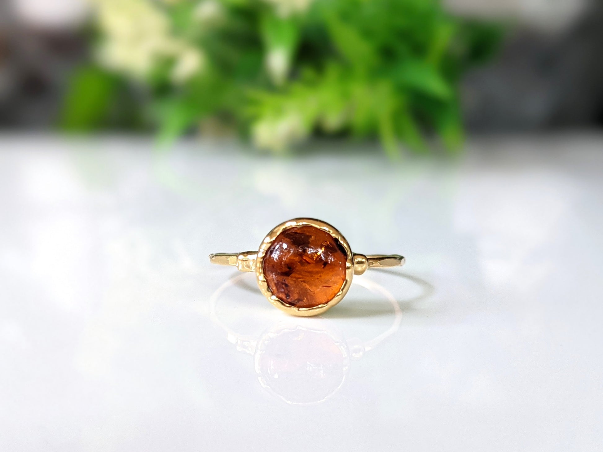 Stunning Baltic Amber gold ring featuring an 8mm round stone set on a hammered 14k gold filled band.