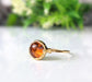 Baltic Amber gold ring featuring an 8mm round stone set on a hammered 14k gold filled band.