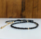 Elegant black spinel bead necklace with gold accents, perfect for gifts and special occasions.