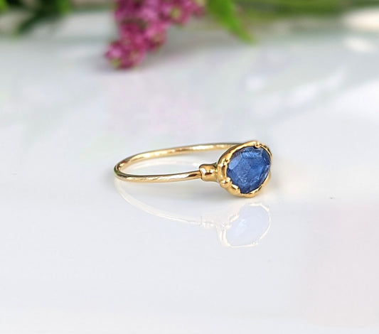 Blue rose-cut Kyanite stone set in a solid 14k gold band, showcasing a unique and elegant design.