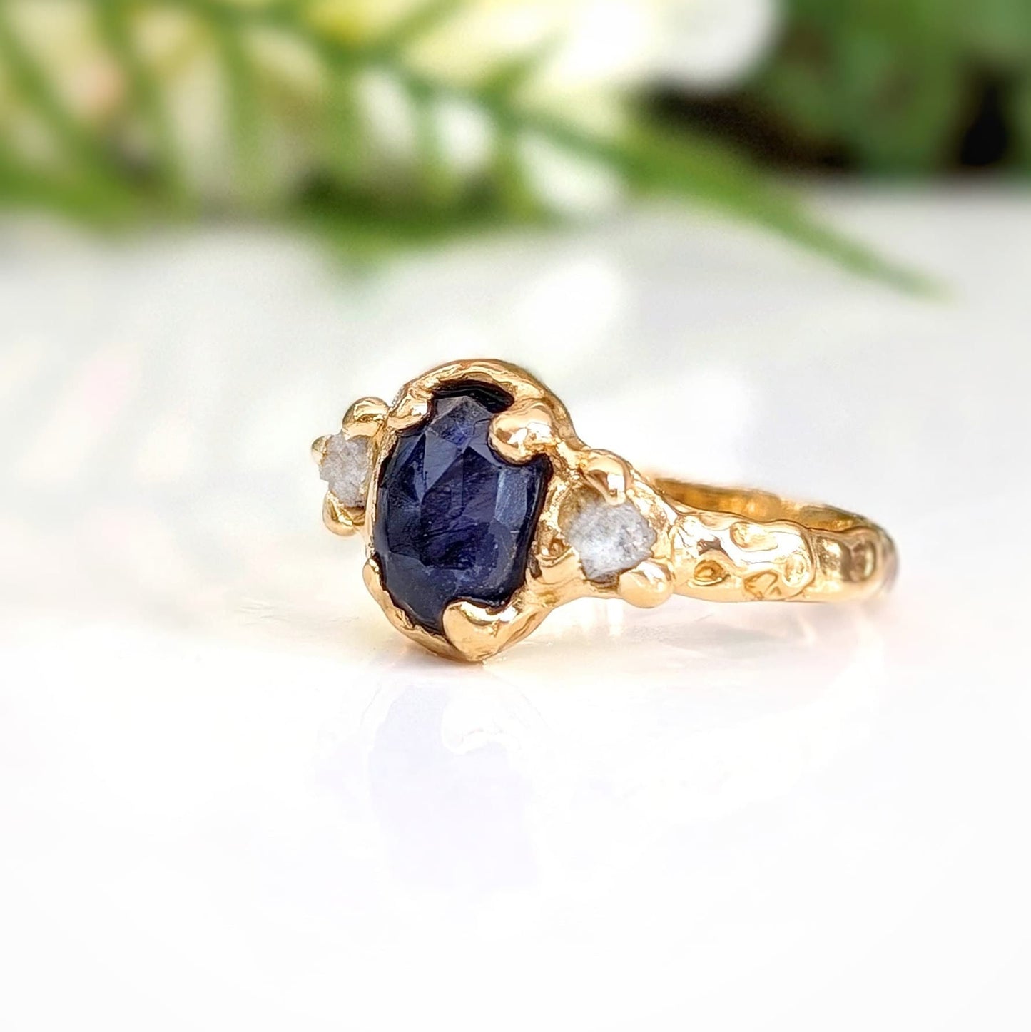 Blue Sapphire and diamond engagement ring in 14k gold with unique textured design, showcasing a stunning sapphire and raw diamonds.