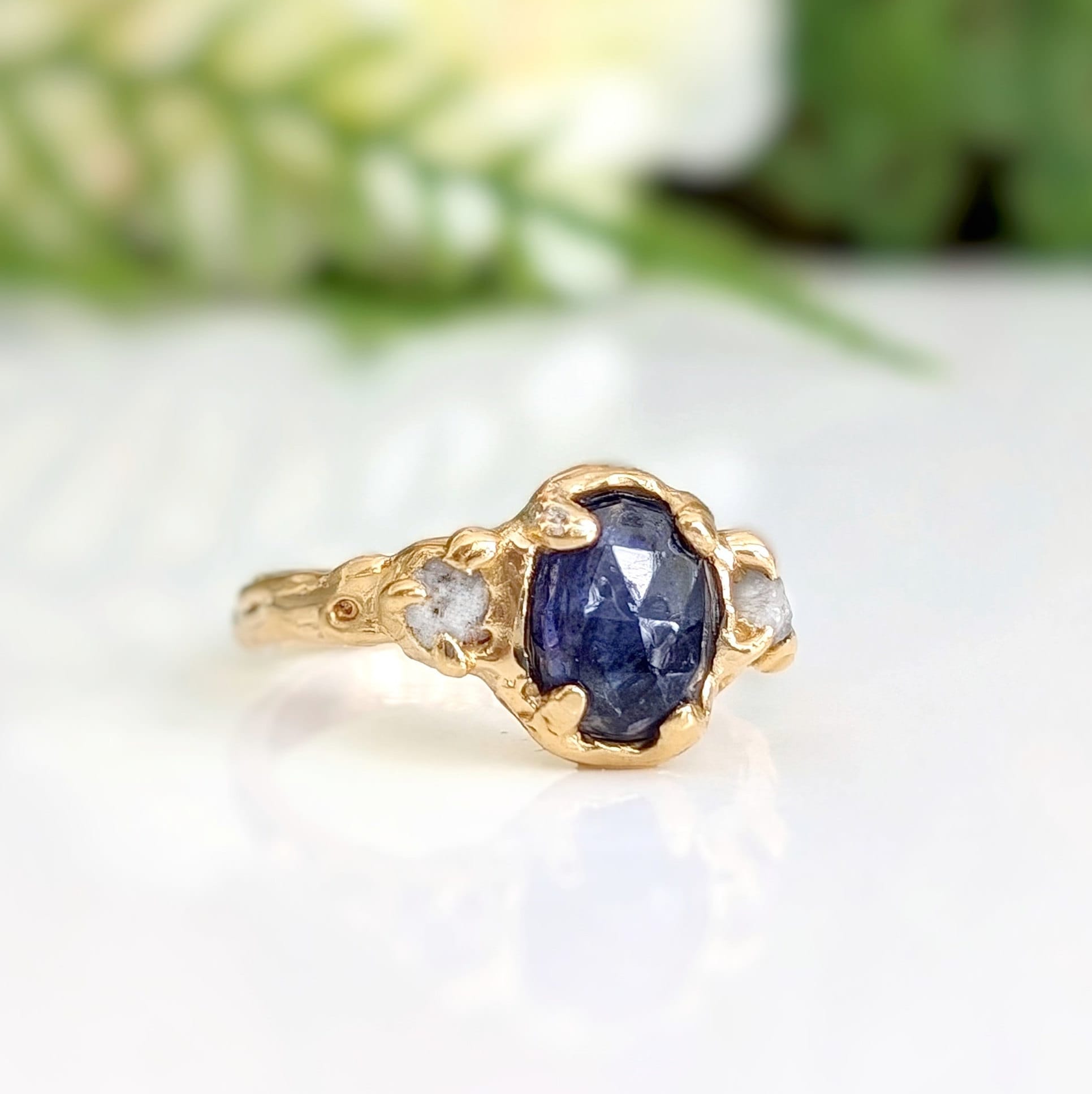 Blue Sapphire and diamond engagement ring in solid 14k gold with a textured design, showcasing natural elegance.