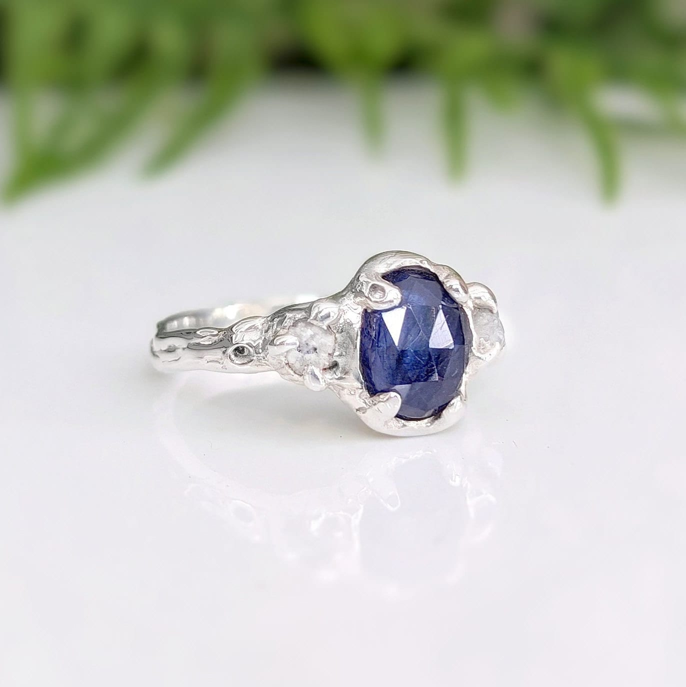 Blue sapphire and raw diamond engagement ring in solid sterling silver showcasing a nature-inspired design.