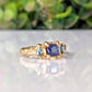 Blue Sapphire and Tourmaline engagement ring in solid 14k gold with organic texture, featuring a square sapphire and teal tourmalines.
