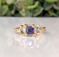 Organic Blue Sapphire engagement ring in solid 14k gold with teal tourmalines, showcasing rustic elegance.