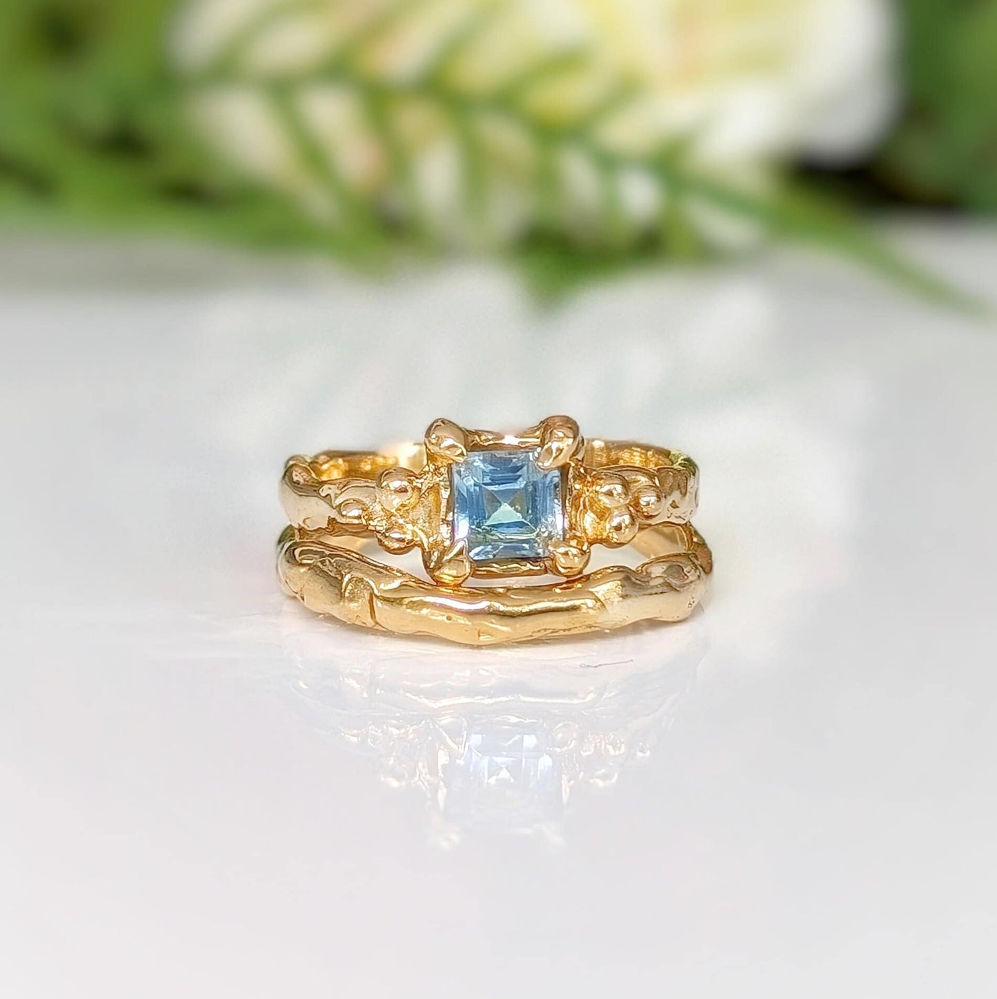 14k gold engagement ring featuring a London Blue Topaz, handcrafted with an organic textured band.