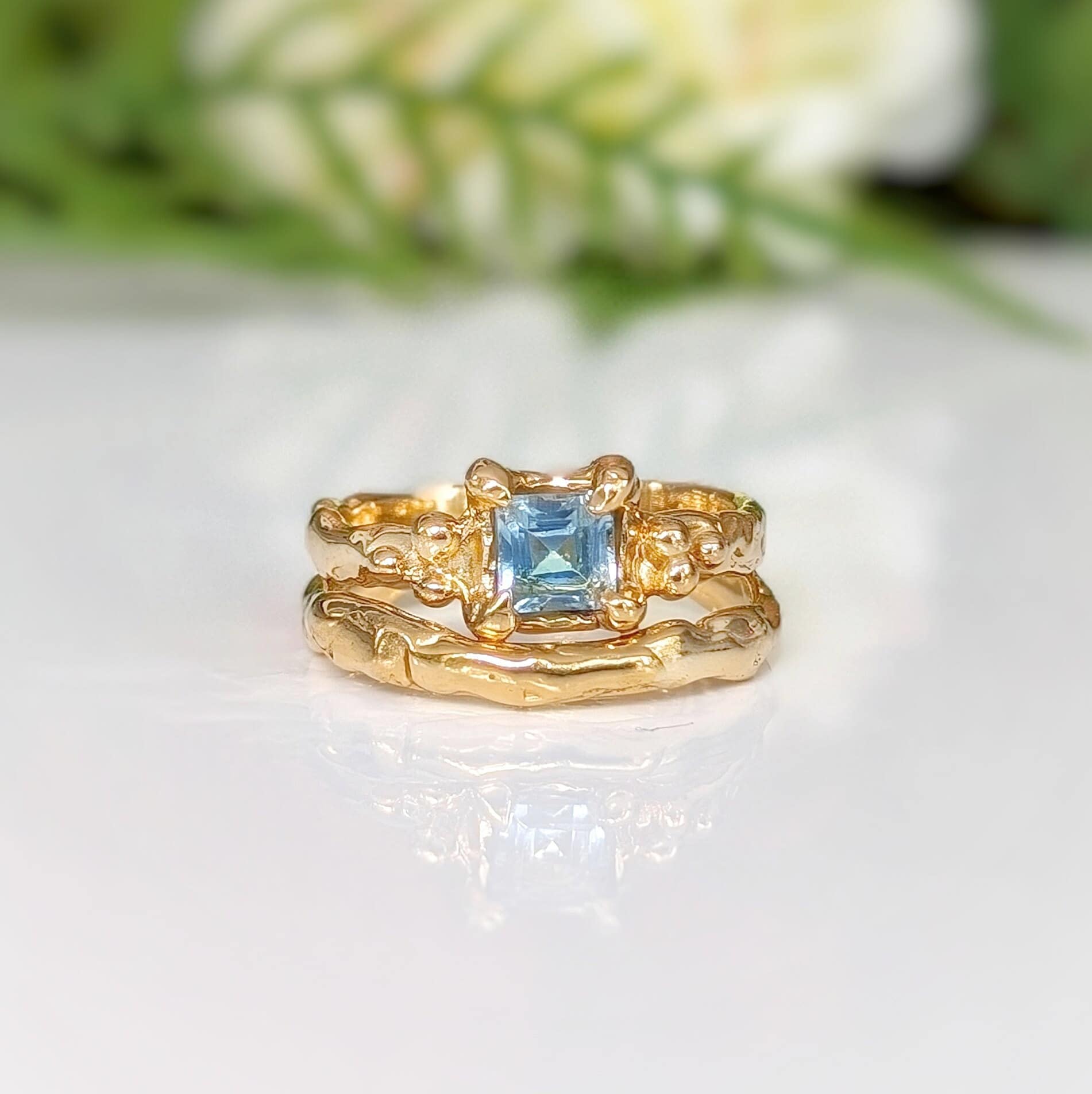 14k gold engagement ring featuring a London Blue Topaz, handcrafted with an organic textured band.