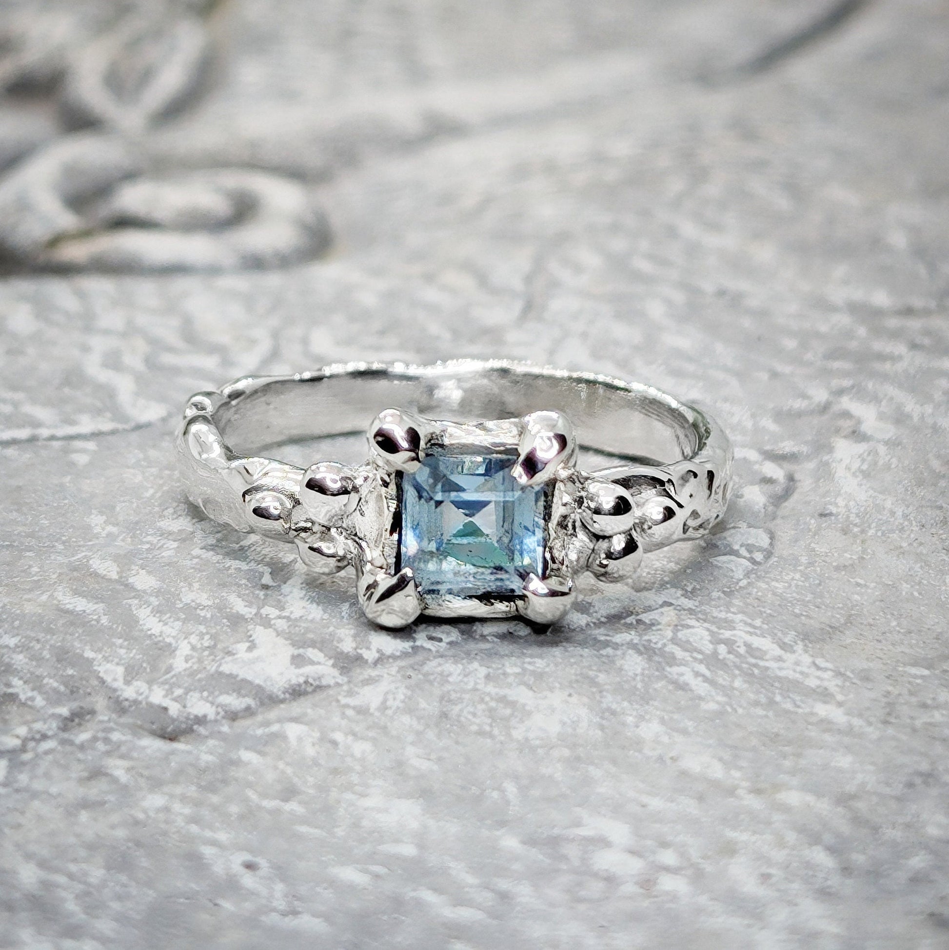Handcrafted London Blue Topaz engagement ring in solid sterling silver with an organic textured band.