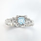 Handcrafted blue topaz engagement ring in sterling silver with organic textured band.