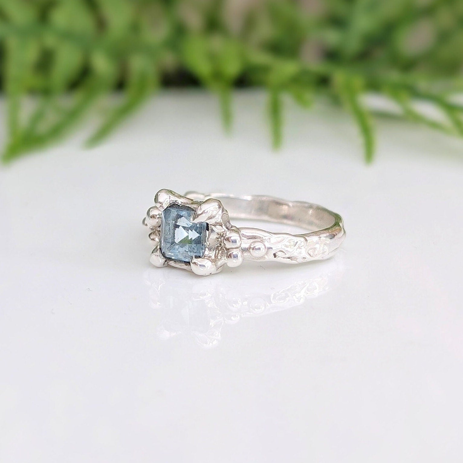 London Blue Topaz engagement ring in sterling silver with an organic textured band.
