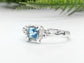 Handcrafted London Blue Topaz engagement ring in organic textured sterling silver.