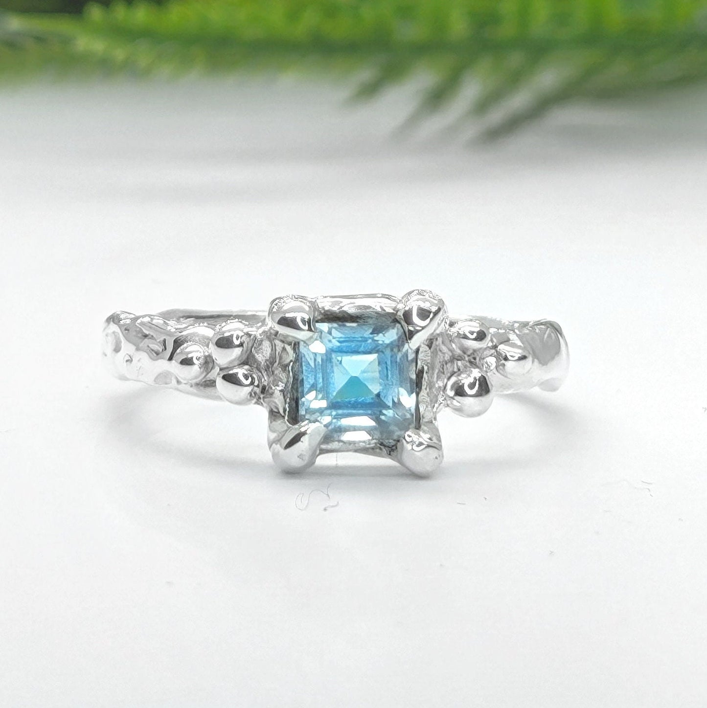 Blue Topaz engagement ring in solid sterling silver with an organic textured band.