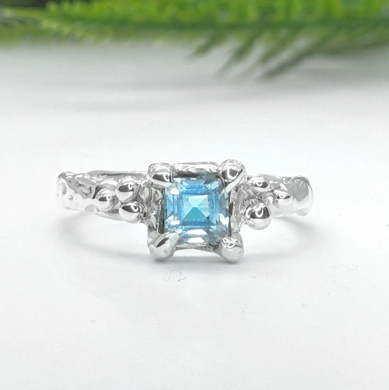 Blue Topaz engagement ring in solid sterling silver with an organic textured band.