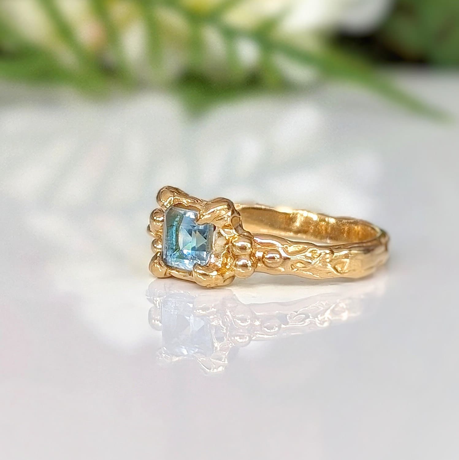 Solid 14k Gold engagement ring featuring a London Blue Topaz and unique organic textured band.