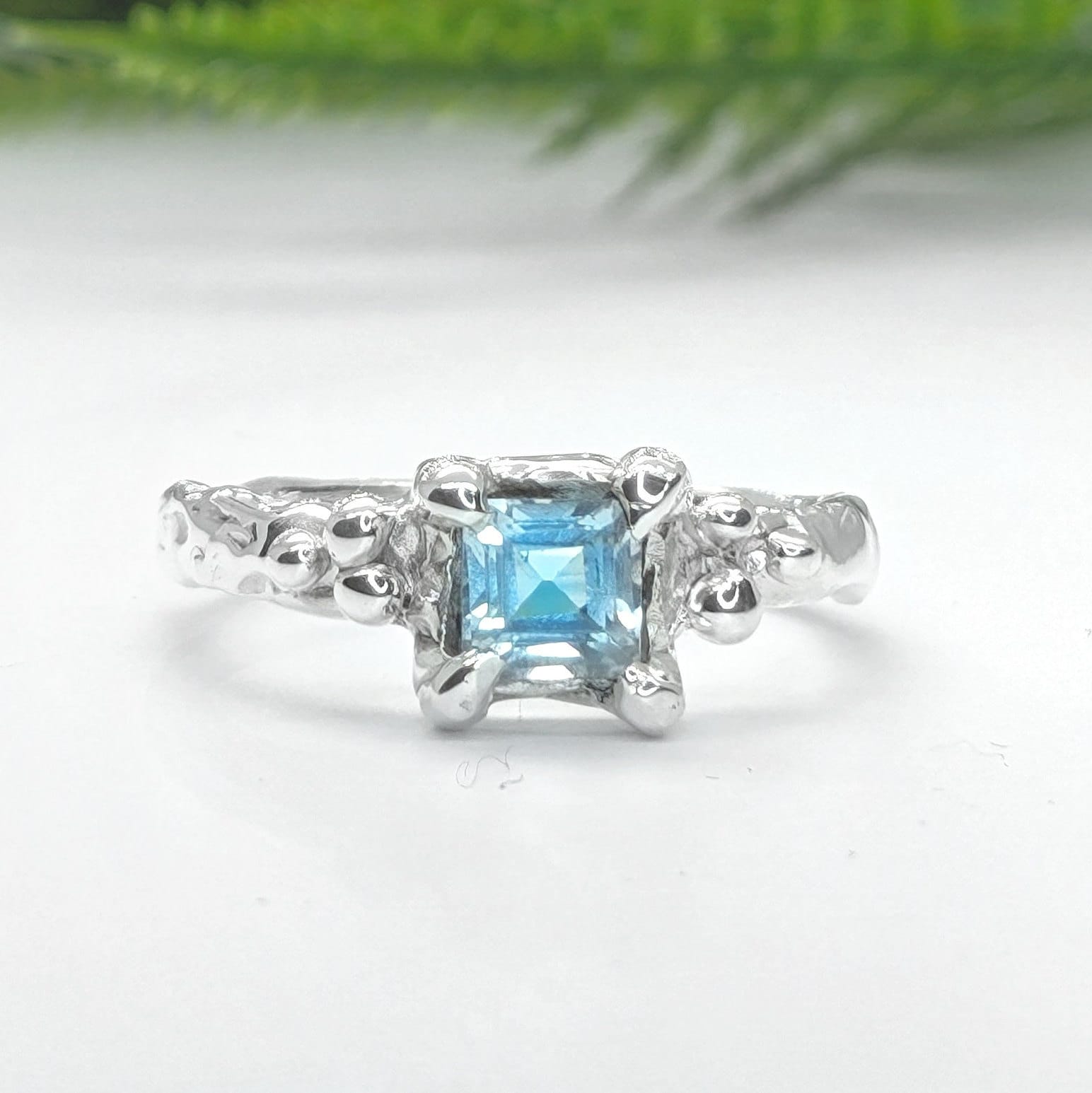 Solid 14k gold engagement ring featuring a unique London Blue Topaz in an organic textured band.