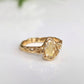 Citrine ring in solid 14k gold with a pear-shaped yellow crystal and textured band, perfect for engagement.