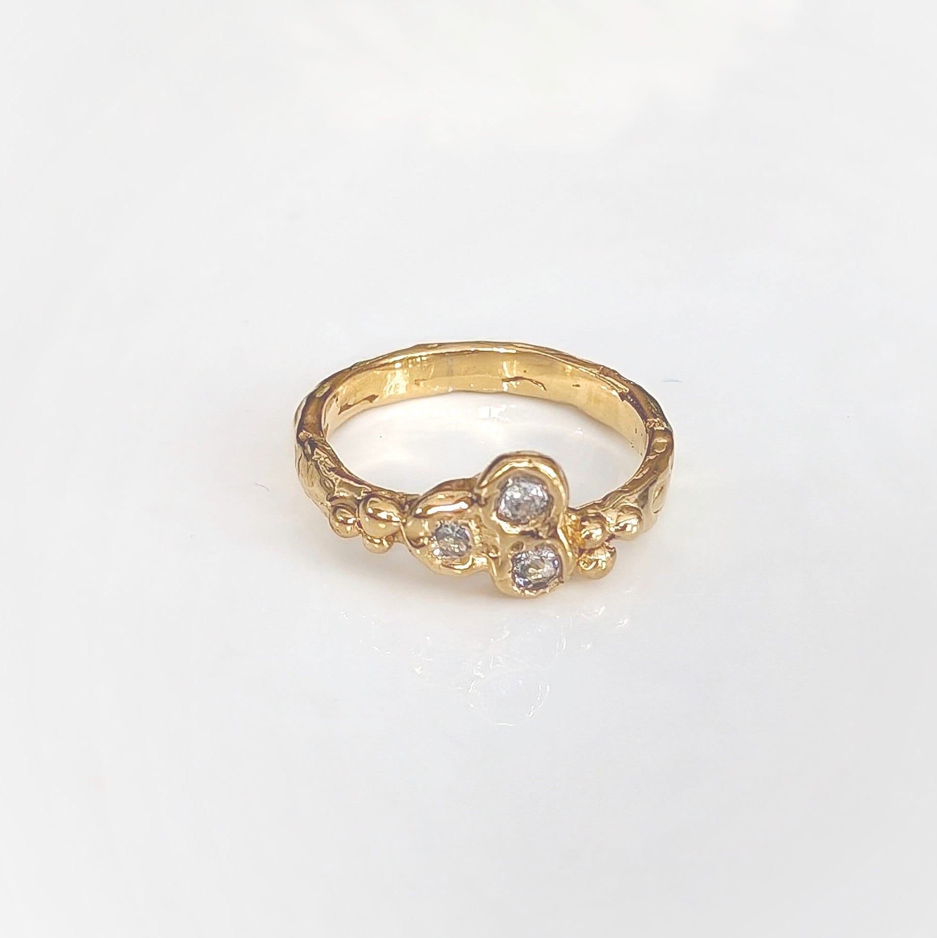 Cubic Zirconia cluster ring in solid 14k gold, featuring an organic textured band and sparkling stones.