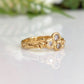 Cubic Zirconia cluster ring in solid 14k gold with organic textured band, showcasing brilliant stones.