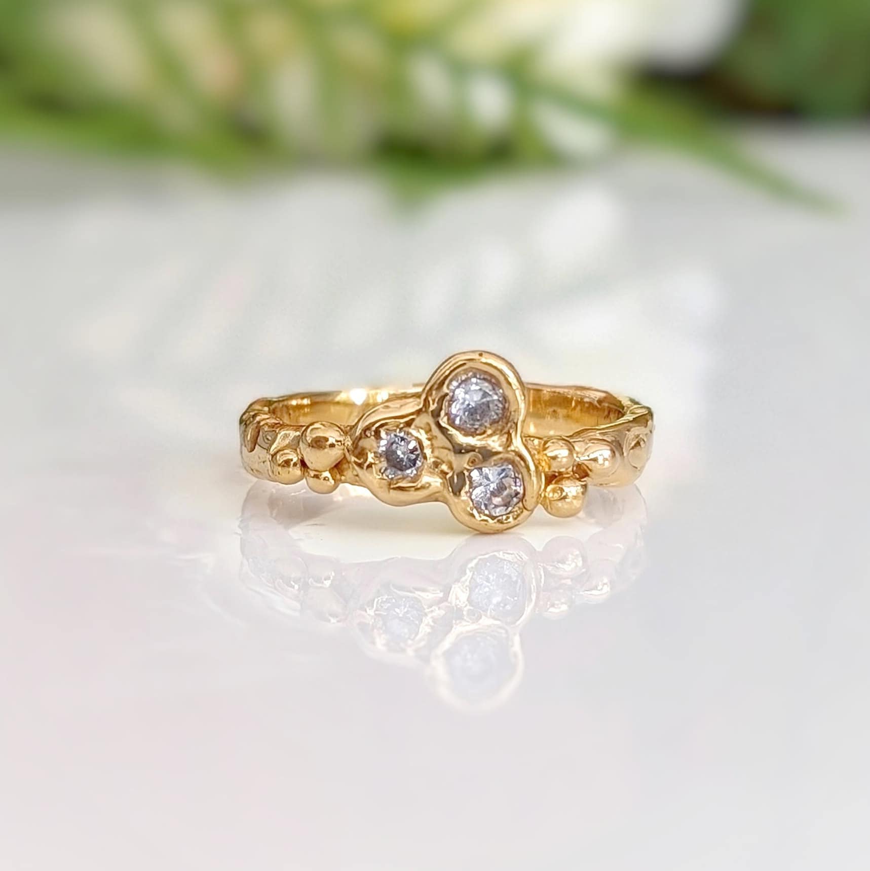 Cubic Zirconia cluster ring in Solid 14k Gold, featuring three sparkling stones on an organic textured band.