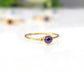 Dainty gold stacking ring featuring a small natural purple Amethyst gemstone for minimalist jewelry lovers.