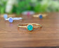 Dainty emerald stacking ring with a 4mm natural green emerald on a gold filled band, perfect for minimalist style.