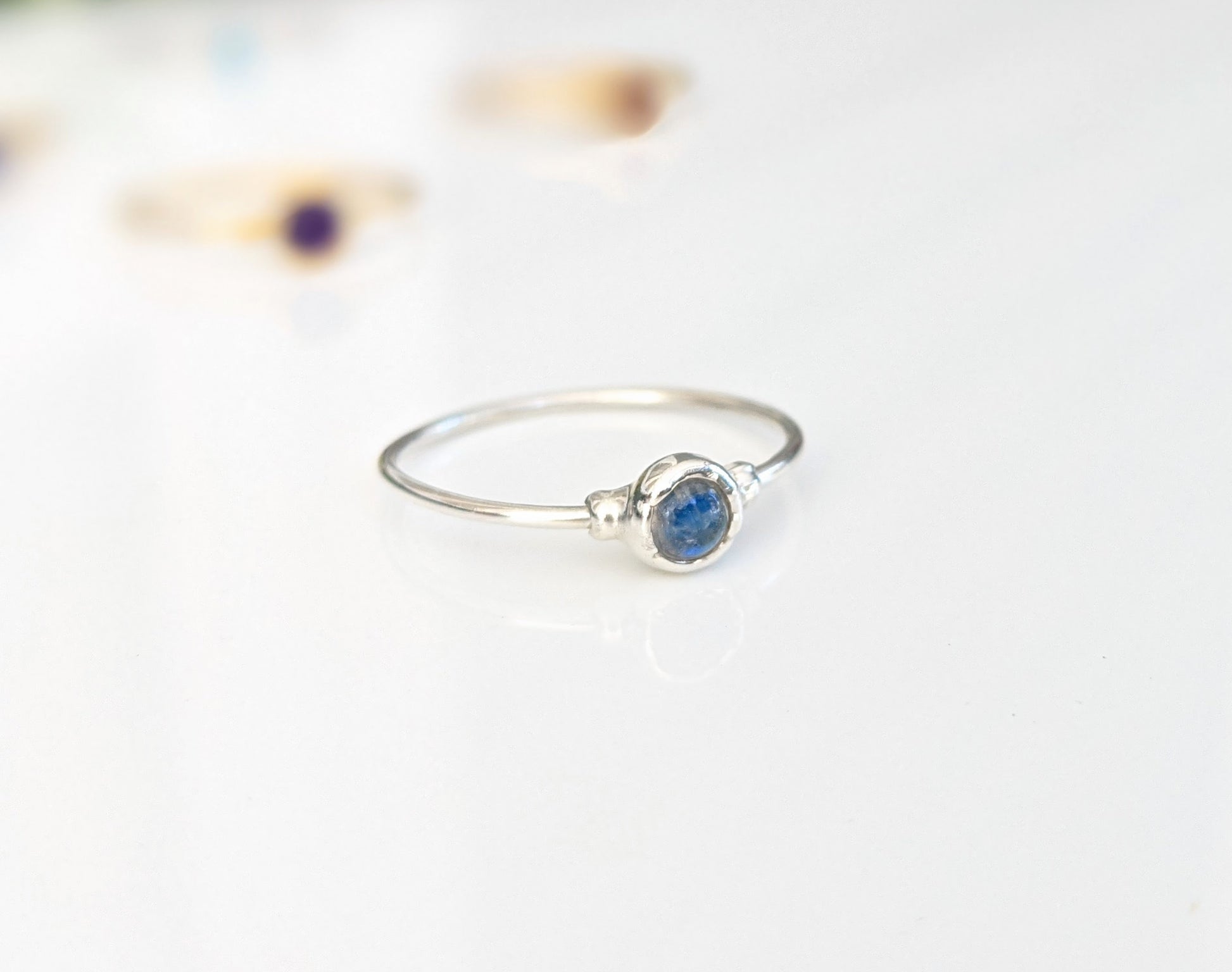 Dainty silver ring featuring a natural blue gemstone, perfect for stacking or as a minimalist everyday piece.