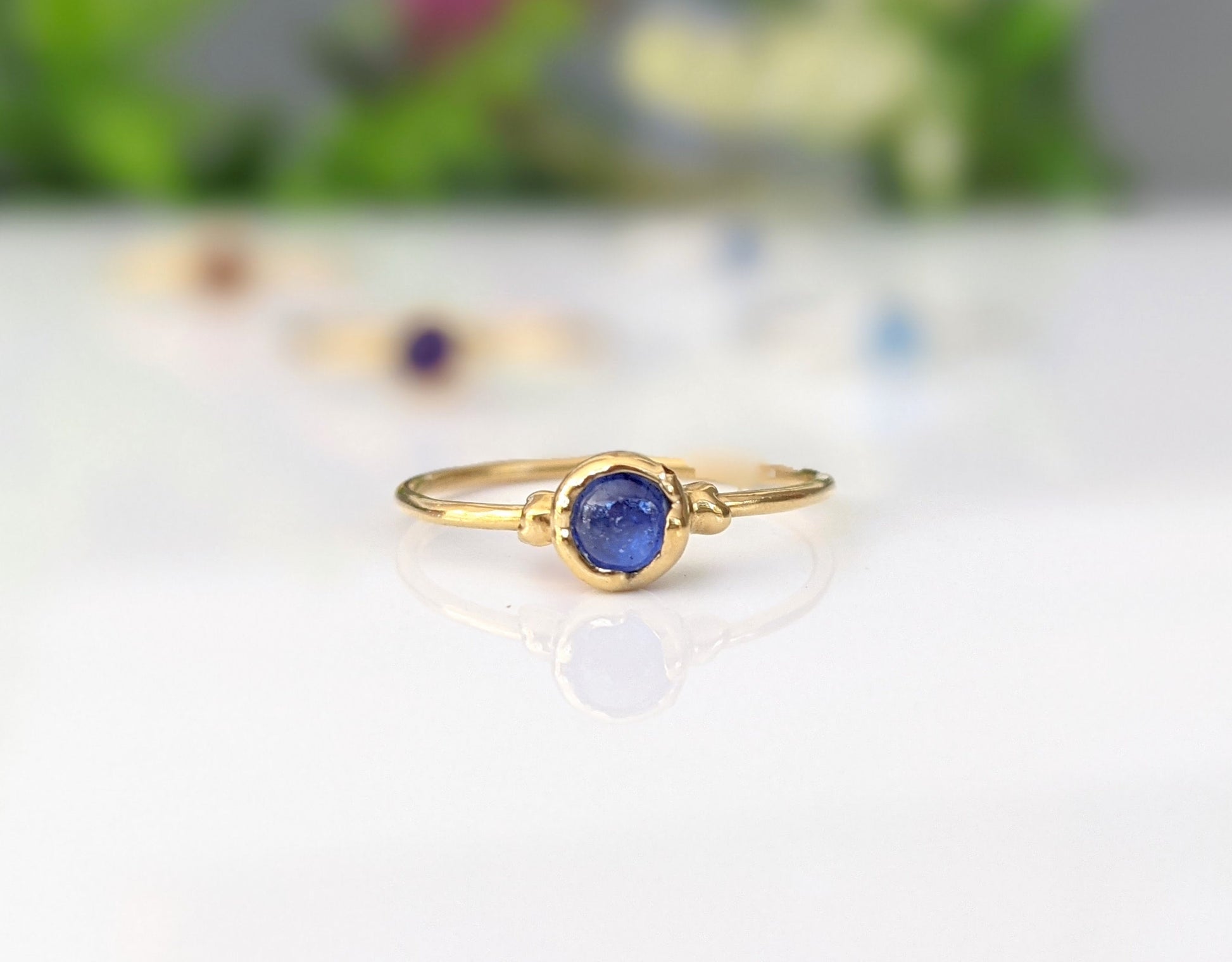 Dainty sapphire stacking ring with natural blue gemstone on a gold-filled band, perfect for everyday wear.