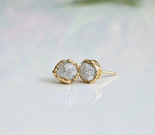 Handcrafted raw diamond stud earrings in gold, radiating natural beauty and elegance.