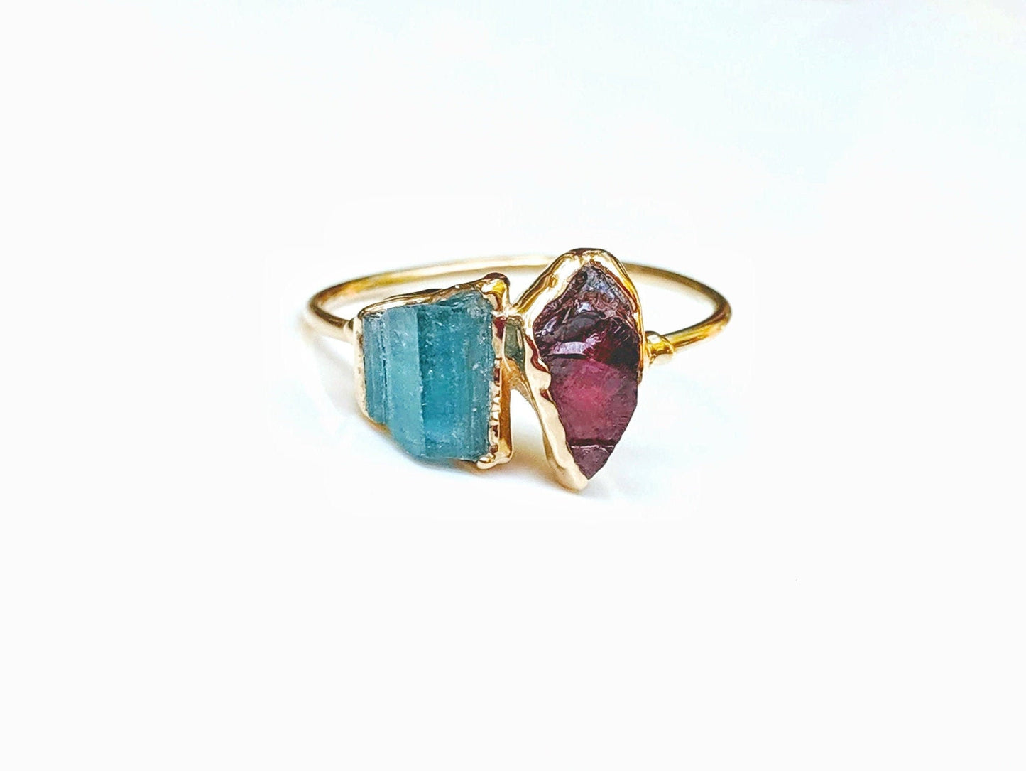 Unique raw gemstone Mother's ring featuring blue and red birthstones in gold band.