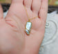Handcrafted Biwa Keshi Pearl Kintsugi necklace in gold on a hand, showcasing unique design and elegance.