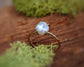 Freshwater Keshi pearl ring in 18k gold setting, showcasing a unique design on a rustic wooden surface.