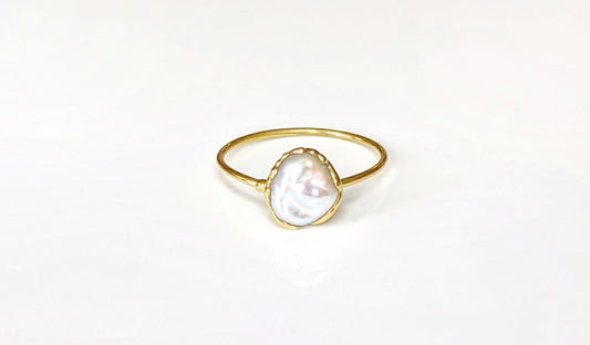 Small freshwater Keshi pearl ring on a solid 14k gold band, showcasing elegant simplicity and handcrafted beauty.