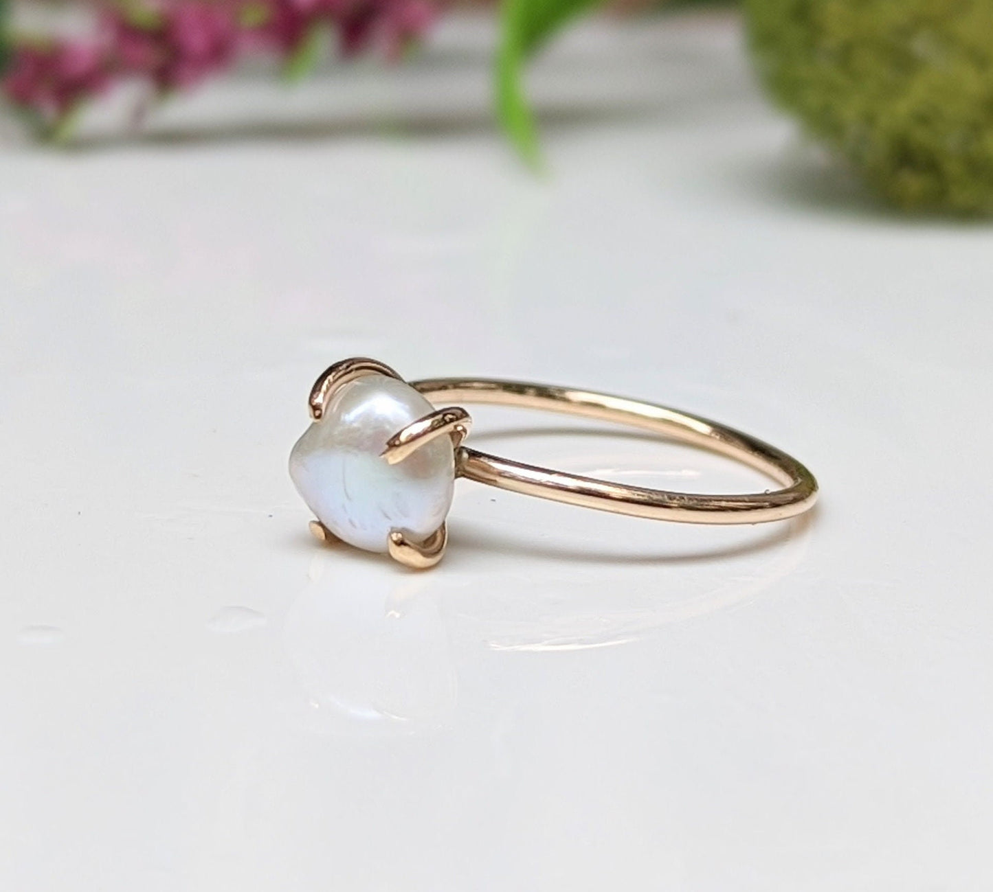 Freshwater Keshi pearl solitaire ring in 18k gold with soft reflections, perfect for engagement or special occasions.